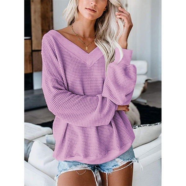 Suéter de punto holgado con cuello en V y diseño de cuadros.